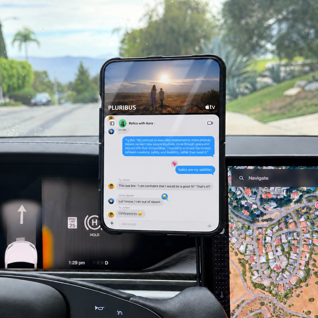 Unfolded iPhone Duo mounted to a MagBak charger in a Tesla Model X